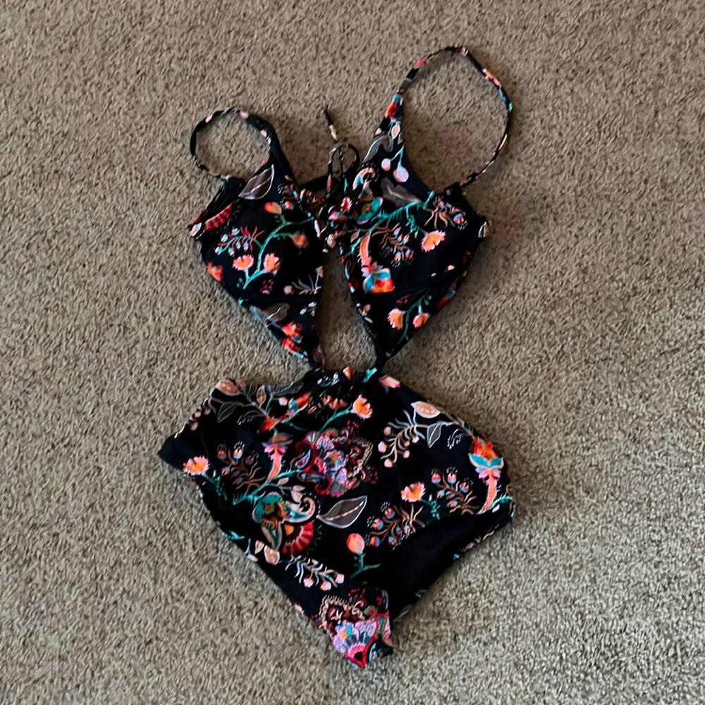 Twist one piece. Black with floral print.